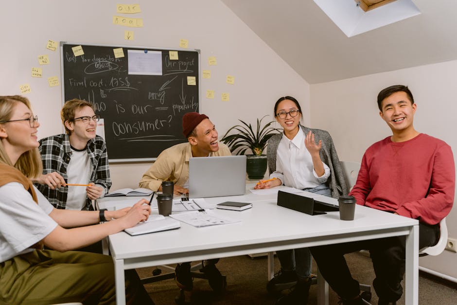 A diverse team sharing a laugh in a relaxed office setting.