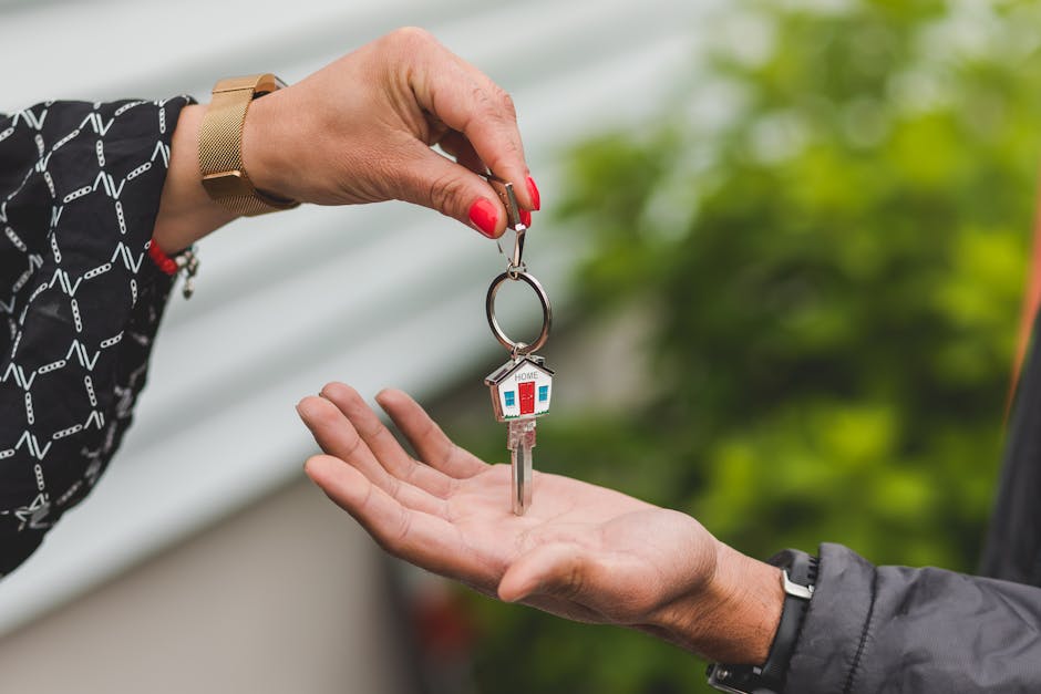 A set of house keys held in an open palm.